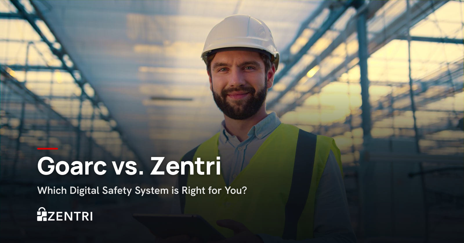 Smiling engineer in a hard hat and hi-vis vest holding a tablet in a factory