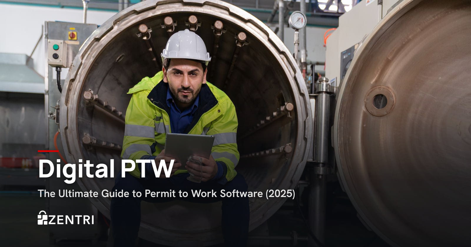 Engineer in a hard hat holding a tablet at the door of a steam boiler